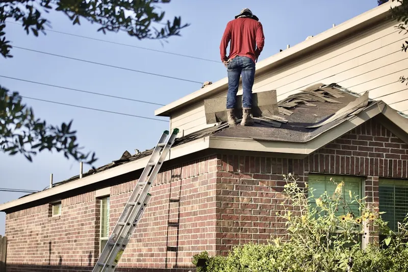 Professional roofer working on a residential roof in Fire Island